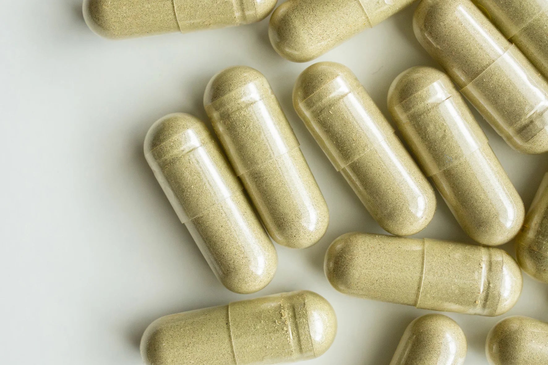 several capsules or pills arranged on a white background.