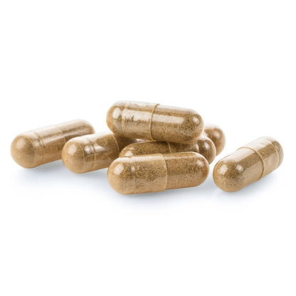 a pile of brown capsules or pills on a white background.
