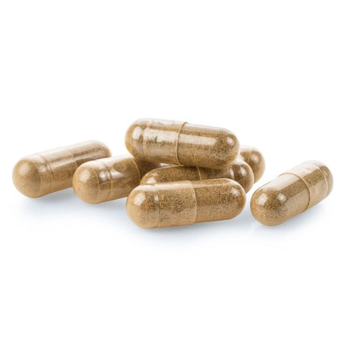 a pile of brown capsules or pills on a white background.