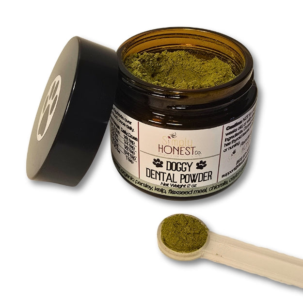 a jar of doggy dental powder with a scoop of the powder on the side, and a black lid with a paw print symbol on it.