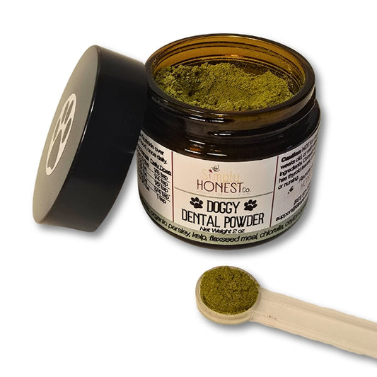 a jar of doggy dental powder with a scoop of the powder on the side, and a black lid with a paw print symbol on it.