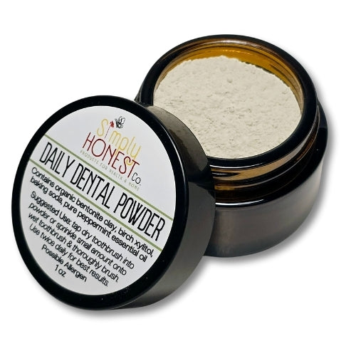 a jar of dental powder with a label on it, placed on a white background.