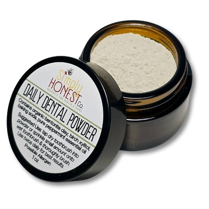 a jar of dental powder with a label on it, placed on a white background.