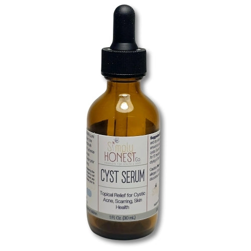 A brown glass bottle with a black dropper, containing a brown liquid and labeled as a "CYST SERUM" for "Topical Relief for Cystic Acne, Scratching, Skin Health".